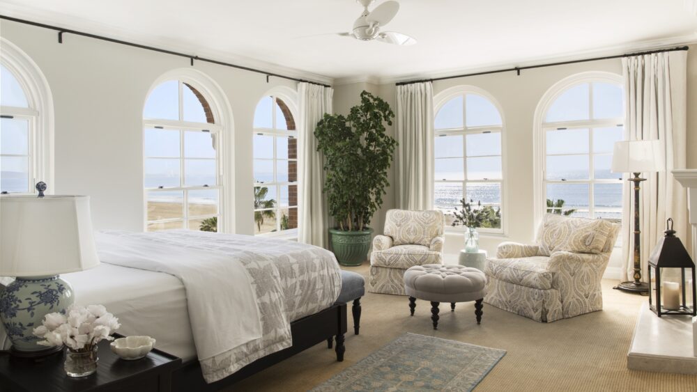 Casa del Mar room with bed, seating area and windows looking out at the ocean