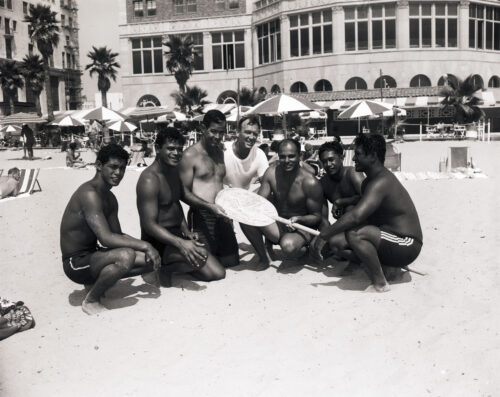 black & white photo of men on the beach in the 1930's