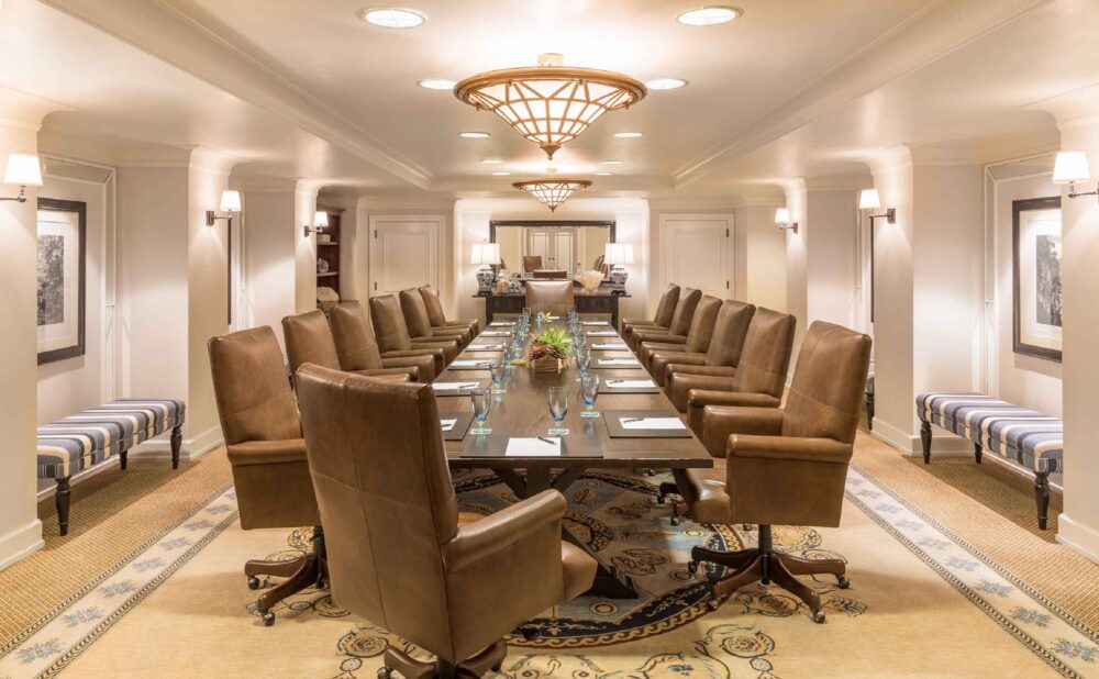 boardroom setup for a meeting with long table and 14 large leather chairs