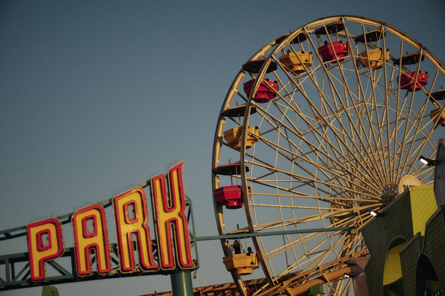 a close up shot of the Santa Monica Pier Farris Wheel and park sign