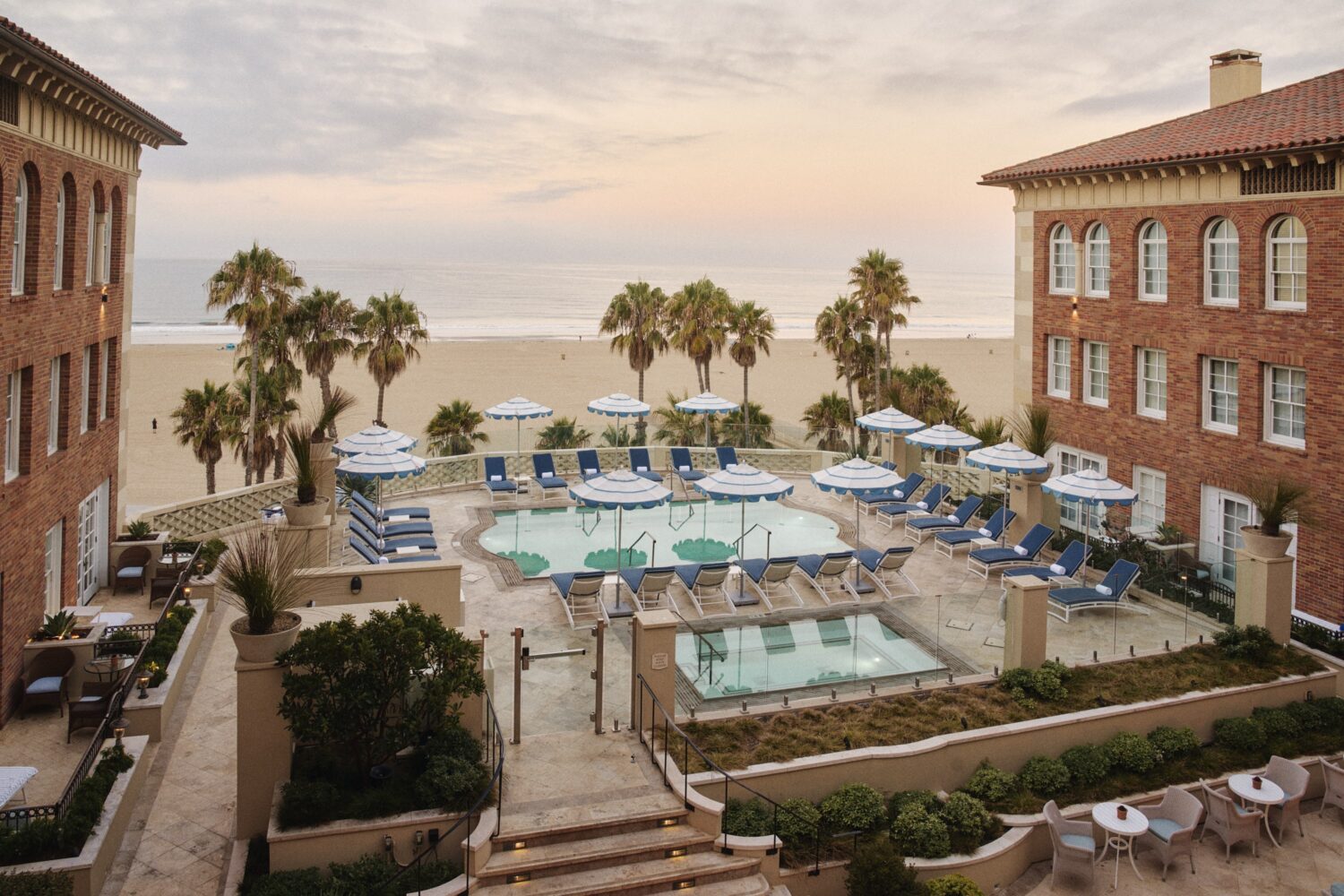 Casa del Mar pool, hot tub and beach view with palm trees between the buildings