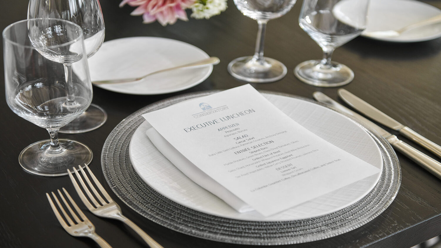 place setting with custom menu for an executive luncheon