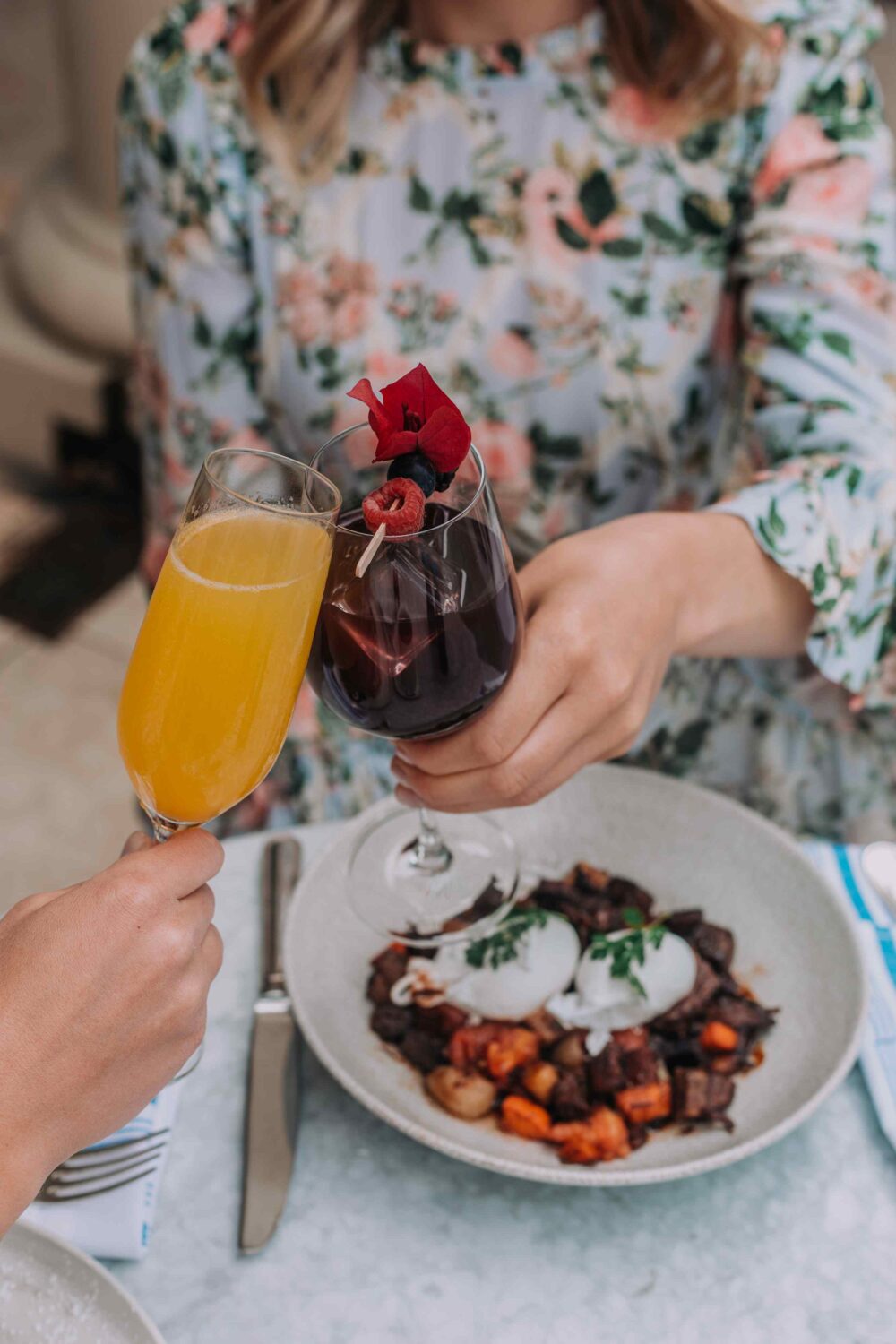 plate of food, and two people clinking their breakfast cocktails