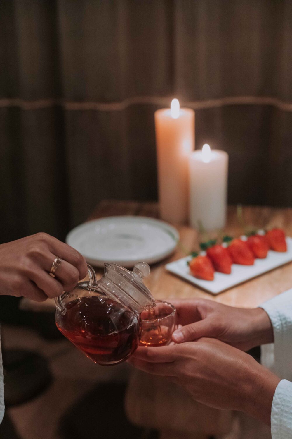 woman pouring tea into another woman's cup in the spa