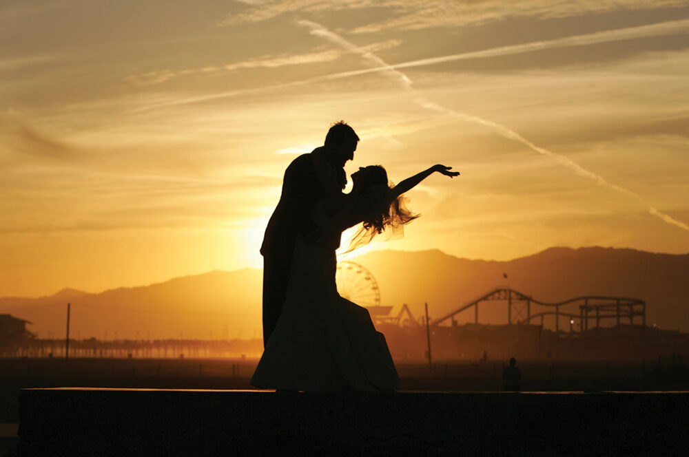 sunset silhouette of a wedding couple with the santa monica pier in the background
